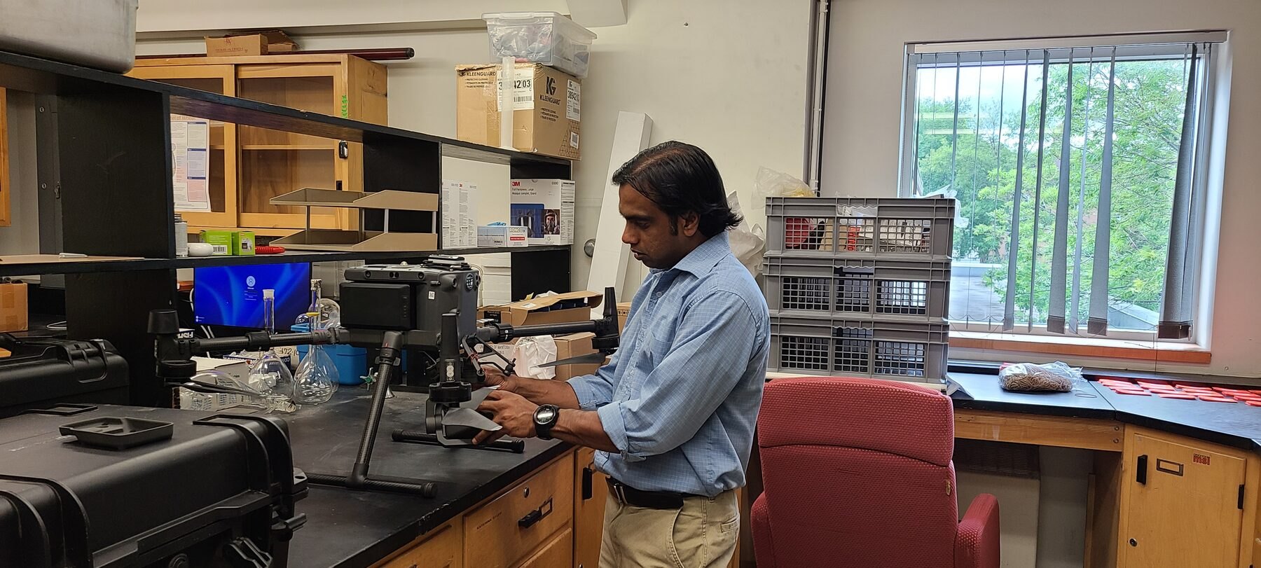 Dr. Dilshan Benaragama working with UAV research equipment in the lab